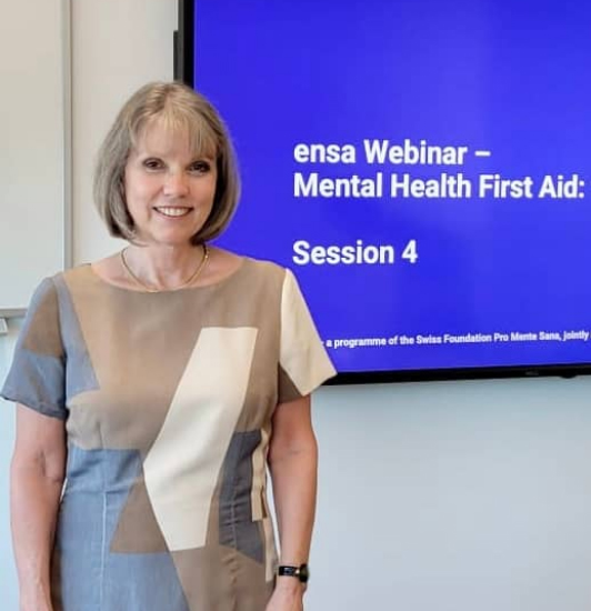 Woman in front of ensa webinar screen for Mental Health First Aid